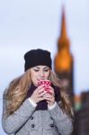 Attractive Young Stylish Blonde Girl Drinks Hot Drink From A Mug Stock Photo