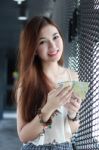 Portrait Of Thai Adult Beautiful Girl Using Her Smart Phone And Smile Stock Photo