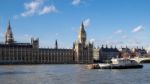 Working Boats In Front Of The Houses Of Parliament Stock Photo