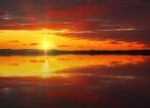 Red Sunset Sky Reflected In The Water Stock Photo