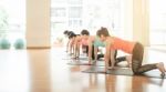 Asian Woman Doing Yoga Indoors Stock Photo