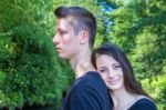 Young Attractive Woman Leaning Head On Back Of Man Stock Photo