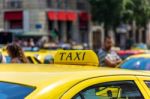 Yellow Taxi Sign On Cab Vehicle Roof Stock Photo