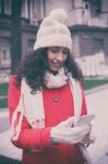 Beautiful Woman In Red Coat And Wool Cap And Gloves With Smartph Stock Photo