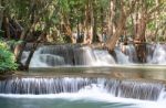 The Water Flowing Over Rocks And Trees Down A Waterfall At Huay Mae Khamin Waterfall National Park ,kanchana Buri In Thailand Stock Photo