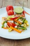 Stir Fry Vegetables In White Dish On Wood Background Stock Photo