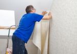 Elderly Worker Smoothing Wallpaper Stock Photo