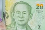 Close Up Of Thailand Currency, Thai Baht With The Images Of Thailand King. Denomination Of 20 Bahts Stock Photo