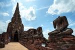 Old Pagoda And Ruined Buddha Statue In Chaiwatthanaram Temple Stock Photo