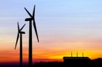 Silhouette Wind Turbine Generator With Factory Emissions Of Carb Stock Photo