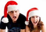 Shouting Couple Wearing Santa Hat Stock Photo