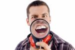 Male Showing Teeth Through Magnifying Glass Stock Photo