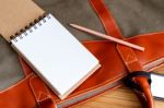 Notebook With Pencil On Travel Bag Stock Photo