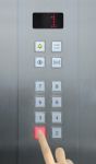 Businessman Hand Press 1 Floor In Elevator Stock Photo