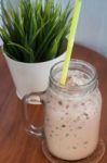 Iced Coffee With Green Plant Background Stock Photo