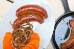 Beef Sausages Cooked On Iron Skillet Stock Photo