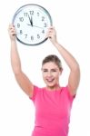 Pretty Girl Holding The Wall Clock Stock Photo