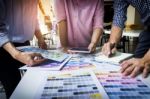 Designers Working Together At Desks In Modern Office Stock Photo