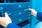 Man Fix Server Network In Data Center Room Stock Photo