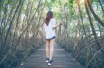 Girl Walking Alone And Hand Holding Camera On A The Wooden Bridg Stock Photo