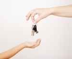 Mother Gives The Keys To His Little Daughter Stock Photo