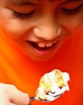 Boy Eating Creamy Puff Stock Photo