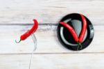 Red Hot Chili Pepper With Water Drops On Fork Stock Photo