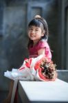 Toothy Smiling Face Of Asian Kid Happiness Emotion And Dry Flowers Bouquet Beside Stock Photo