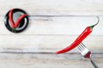 Red Hot Chili Pepper With Water Drops On Fork Stock Photo