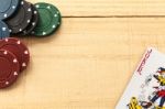 Cards And Poker Chips On Wooden Background Stock Photo