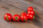 Fresh Tomatoes On The Dark Wooden Table Stock Photo