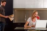 Couple At Home Using Laptop Stock Photo