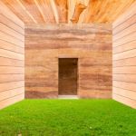 Stone Wall With Door And Green Grass Floor In Wooden Room Stock Photo