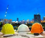 Engineer Working Table With Hard Hat Plan And Writing Tool Again Stock Photo