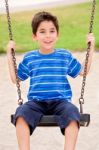 Young Kid Enjoying Swing Ride Stock Photo