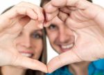 Couple Making Heart Gesture Of Love Stock Photo