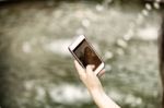 Young  Woman Taking A Photo With Her Phone Stock Photo