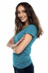 Attractive Female Standing Sideways And Smiling Stock Photo