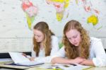 Two Dutch Teenage Girls Studying In Front Of Wall World Chart Stock Photo