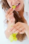 Young Woman In Underwear Eating Grapes. Isolated On White Stock Photo