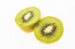 Kiwi Slices Into Half On White Background Stock Photo