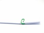 Green Paperclip Attached On White Paper Isolated Stock Photo