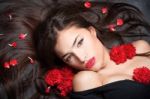 Woman With Long Hair And Carnations Stock Photo