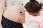 Pregnant Woman And Her Daughter Stock Photo