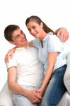 Smiling Teenage Couple Sitting Stock Photo