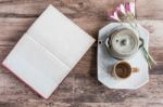 Tea Cups With Teapot With Open Book On Old Wooden Table. Top Vie Stock Photo