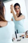 Young Beautiful Woman Making Hairstyle Near Mirror Stock Photo