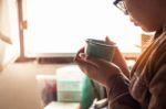 The Girl Was Holding A Coffee At Work Stock Photo