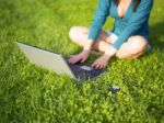 Young Woman Using Laptop And Mobile Phone Stock Photo