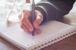 Woman Hand With Pen Writing On Notebook Stock Photo